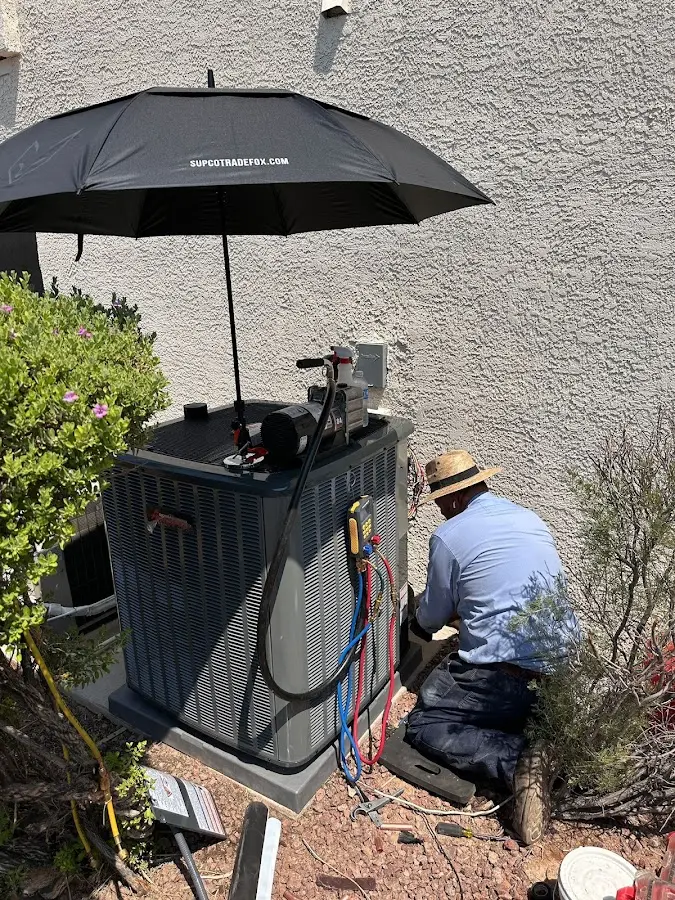 HVAC technician performing outdoor AC maintenance in Westerly